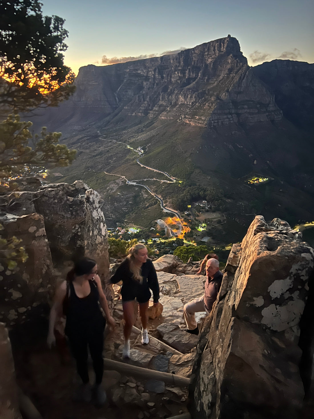 Guided hiking group at sunrise on Lion's Head, Table Mountain in background